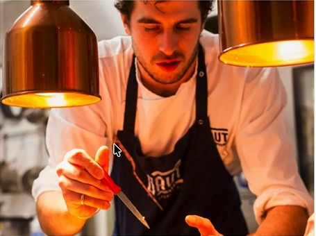 Pizza chef finishing a Neapolitan pizza